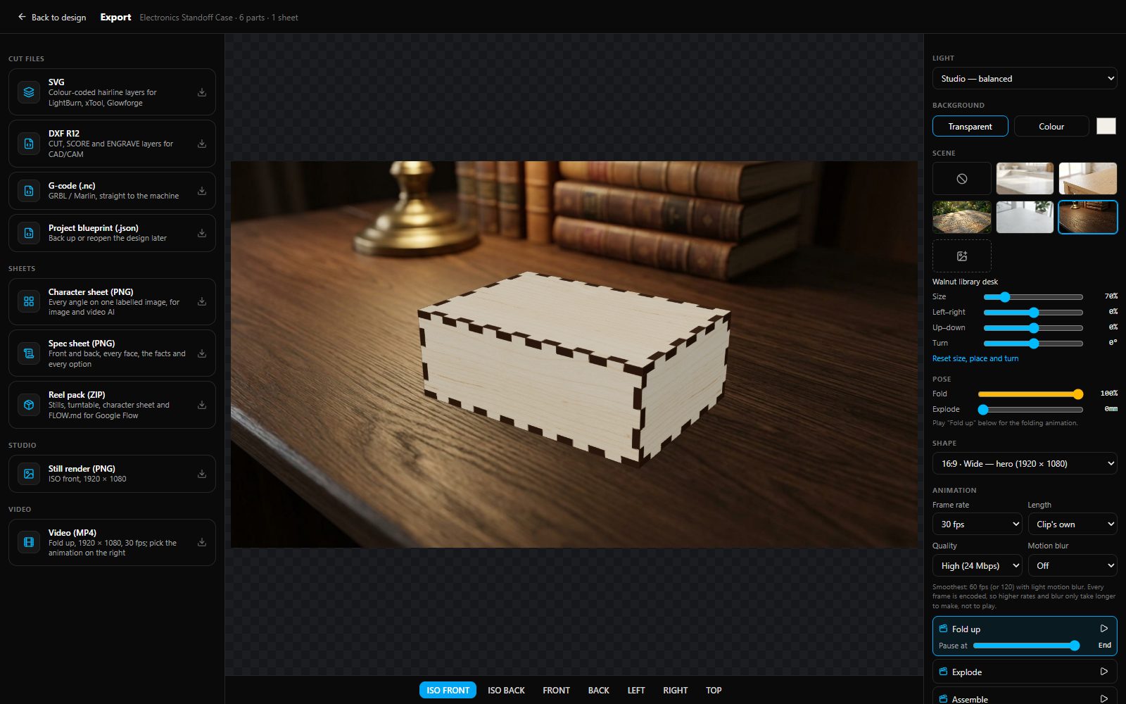 The export studio: cut files on the left, the box rendered on a walnut desk